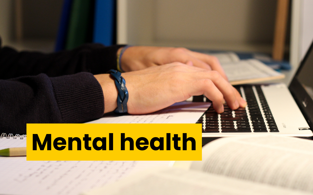 close up of fingers typing on a laptop keyboard. Text reads mental health